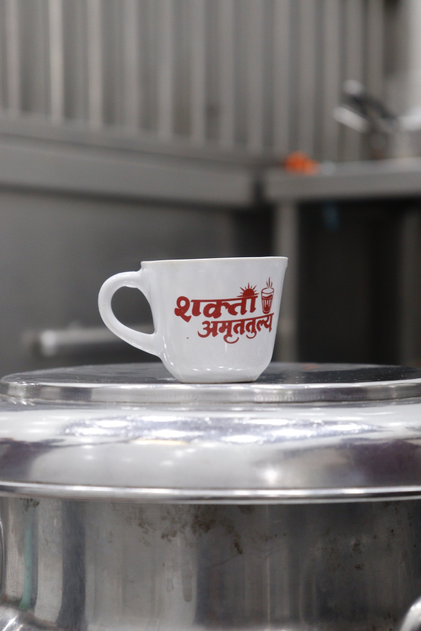 White Shakti Amrutatulya branded tea cup